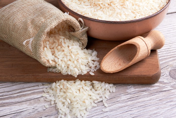 Rice in Bowl On Wooden Background
